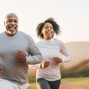 Couple smiling while running outside