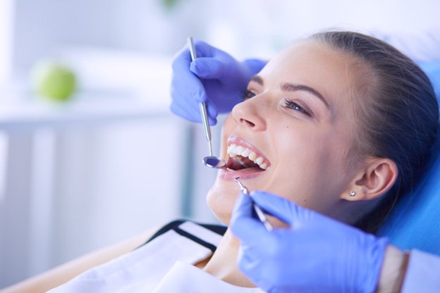 Close up of a dental mirror examining teeth