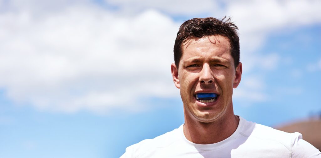 No gum bruises for me. Portrait of a young man wearing a gum guard while playing a game of rugby.