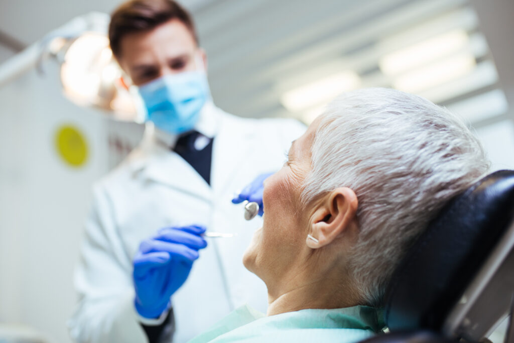 Senior woman having an oral cancer screening during a dental checkup